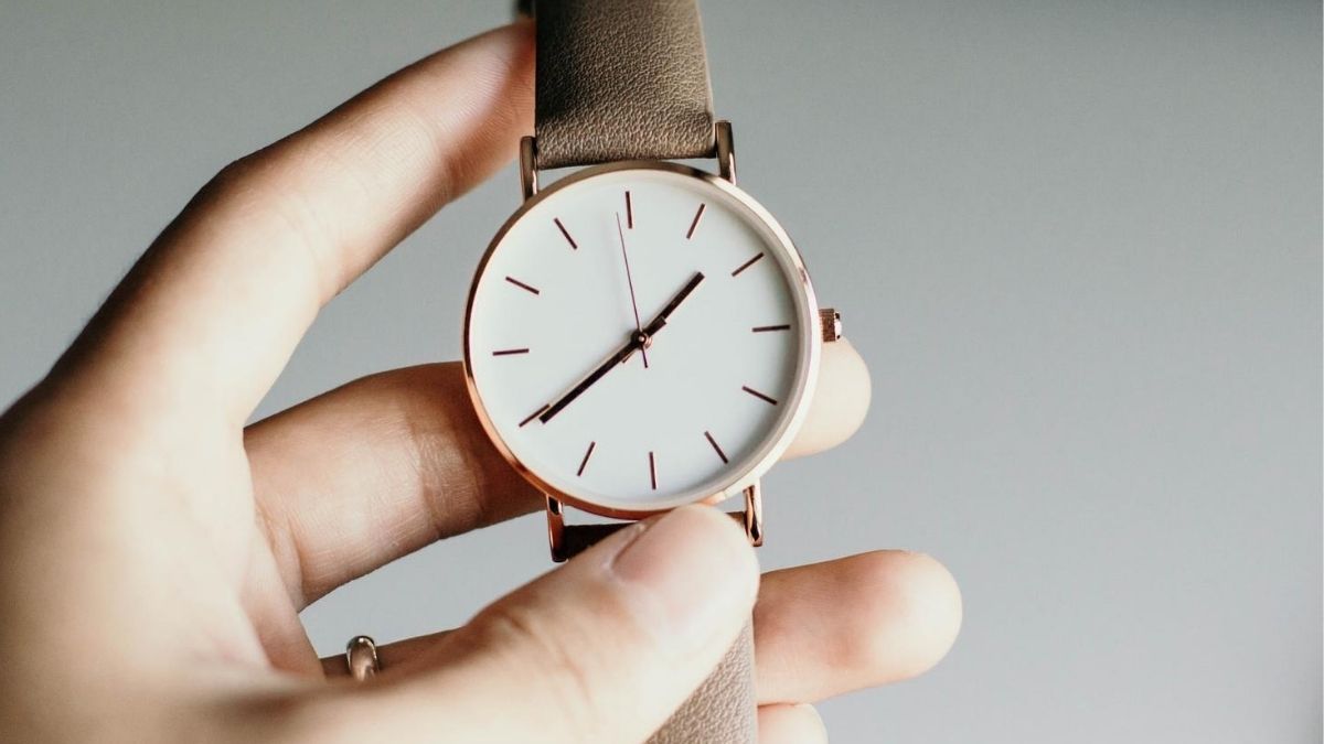 person using watch in hand to help manage time