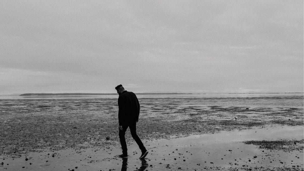 lonely man walking on beach