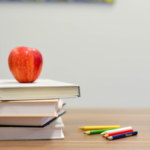 red-apple-on-pile-of-books